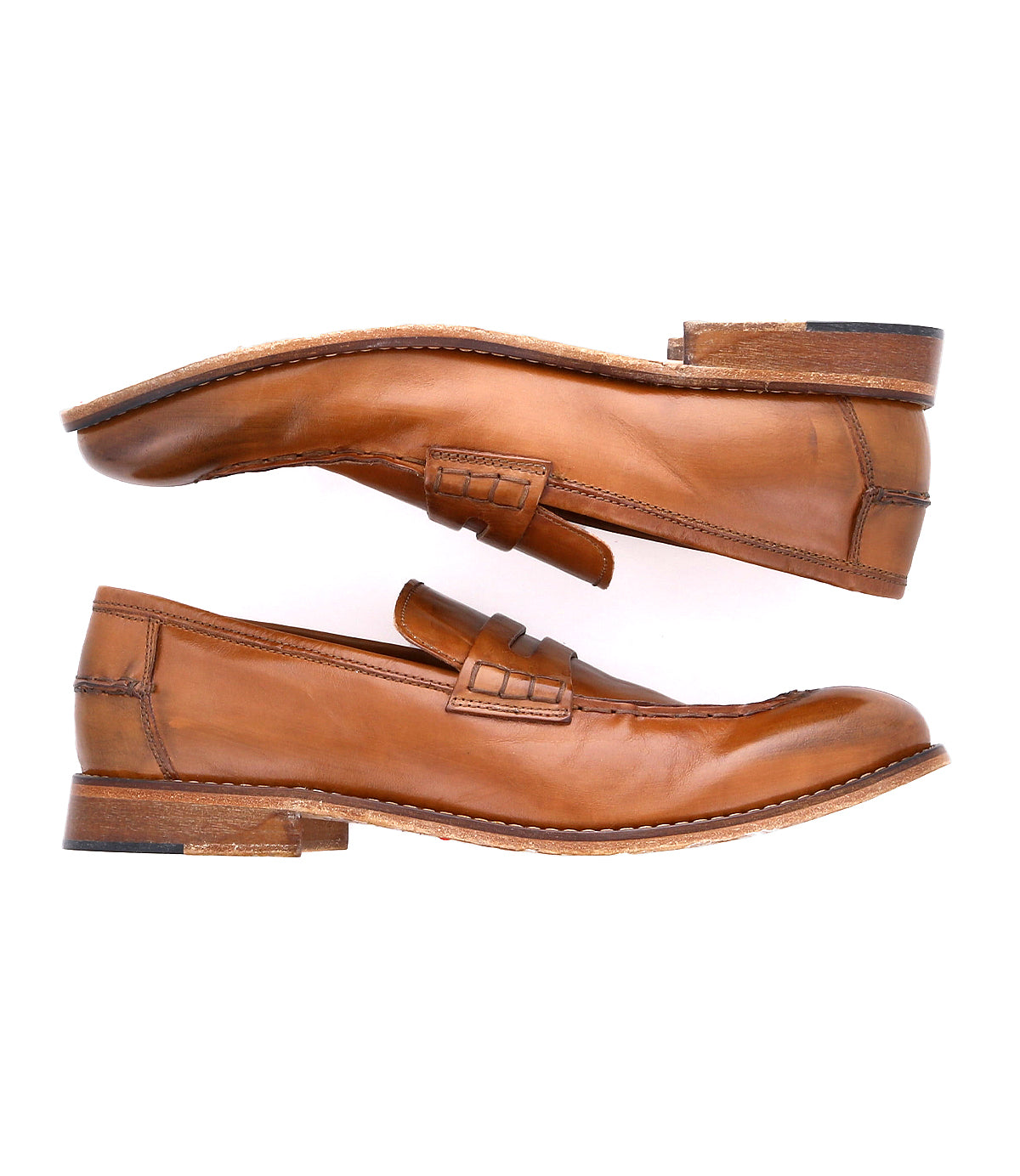 A versatile pair of brown leather penny loafers, viewed from the side, with visible stitching and slightly worn soles, handcrafted in Italy – The Time by Bed Stu.