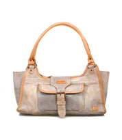 The Bed Stu Unbending is a beige washed leather shoulder bag with tan handles, trim, a front pocket with buckle closure, and a logo patch—ideal as a stylish work bag.