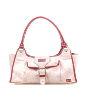 The Bed Stu Unbending is a cream-colored washed leather shoulder bag with red handles and trim, front pocket with buckle detail, and a small rectangular logo patch at the bottom right. Its structured silhouette adds stylish appeal.