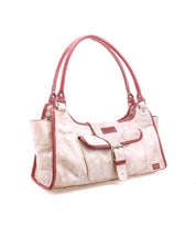 The Bed Stu Unbending is a beige handbag with red trim and handles, featuring a structured rectangular silhouette and front buckle closure, shown against a white background.