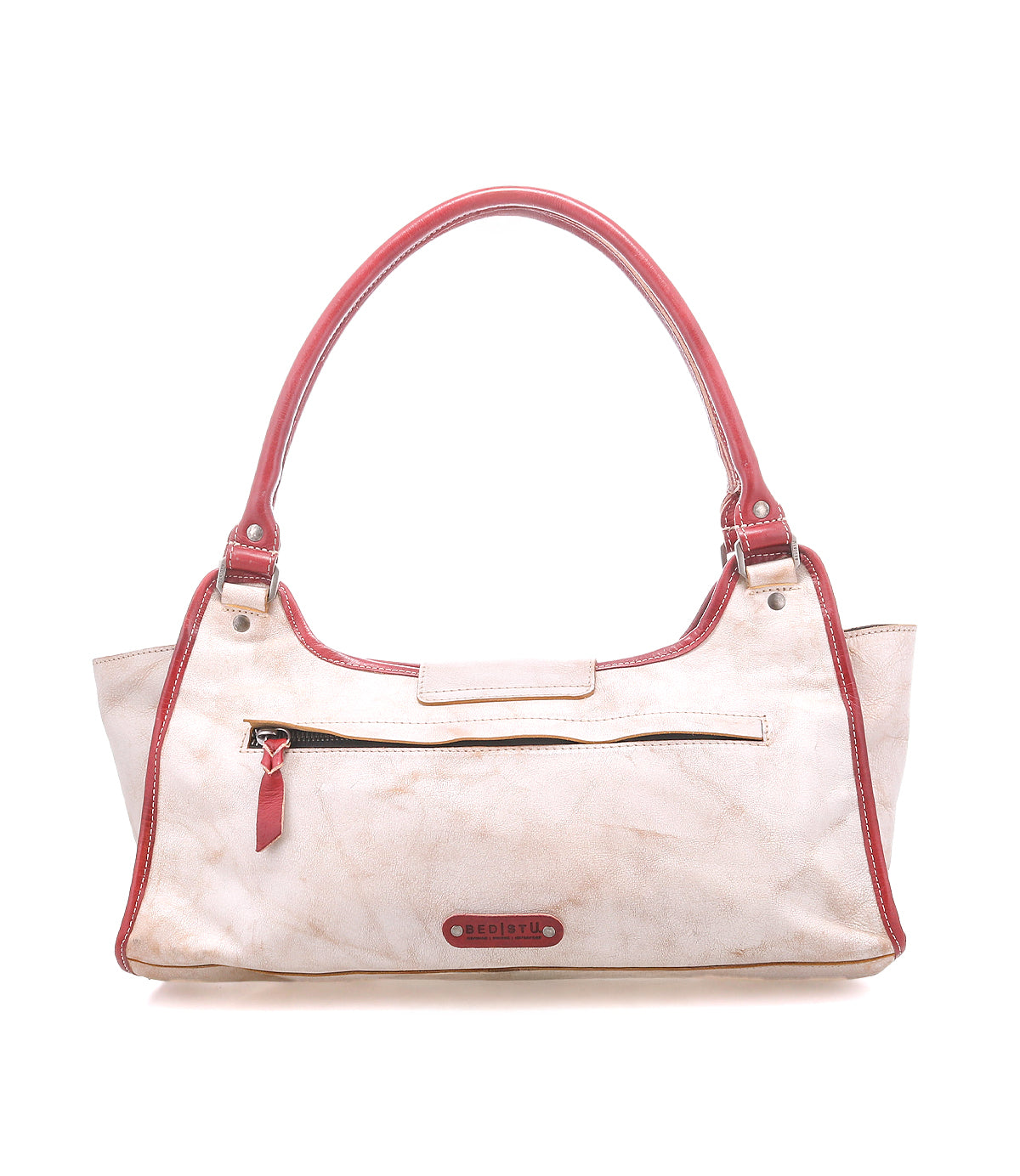 A cream-colored shoulder bag called "Unbending" by Bed Stu, featuring a structured silhouette, red handles and trim, a front zipper pocket, and the brand name on a small tag.