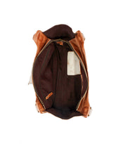 The Bed Stu Unbending shoulder bag in brown washed leather is shown from above, featuring a spacious interior with a zippered pocket, slip pocket, and dark fabric lining.
