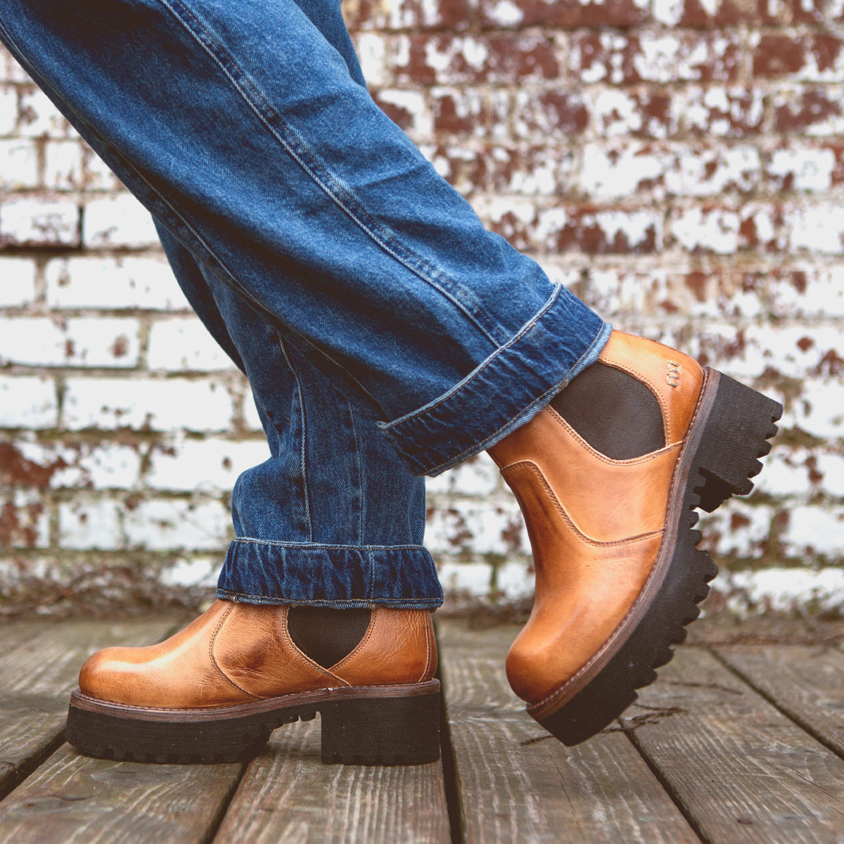 A person wearing a outfit consisting of a pair of Valda Hi jeans styled with a pair of Bed Stu tan Chelsea boots.