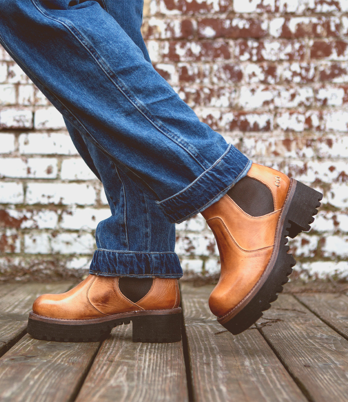 A person wearing a outfit consisting of a pair of Valda Hi jeans styled with a pair of Bed Stu tan Chelsea boots.