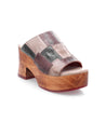 A women's leather clog with an open-toe design and a wooden platform, the Vanquish by Bed Stu.