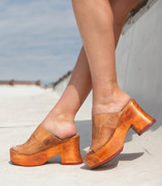 Person wearing Bed Stu Vanquish sustainable fashion wooden platform shoes outdoors.