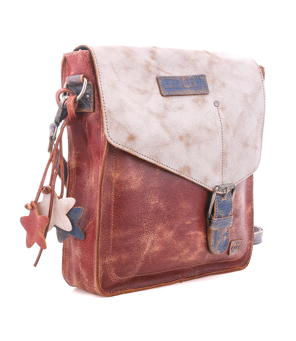 The Bed Stu Venice Beach is a brown and beige full-grain leather crossbody bag featuring a front buckle, star-shaped charms, adjustable strap, and weathered finish, shown on a white background.