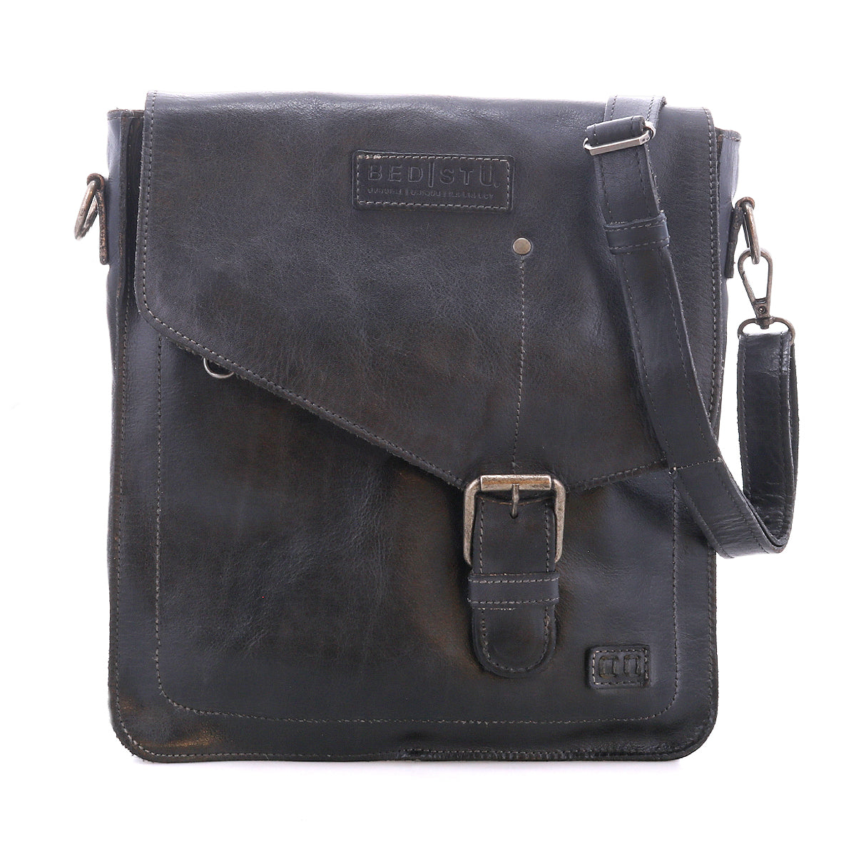 The Bed Stu Venice Beach is a black full-grain leather messenger bag featuring an adjustable shoulder strap, front flap with buckle detail, and Bed Stu branding.