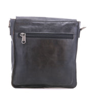 The Bed Stu Venice Beach is a black full-grain leather crossbody bag featuring a front zippered pocket and an adjustable strap, shown against a white background.