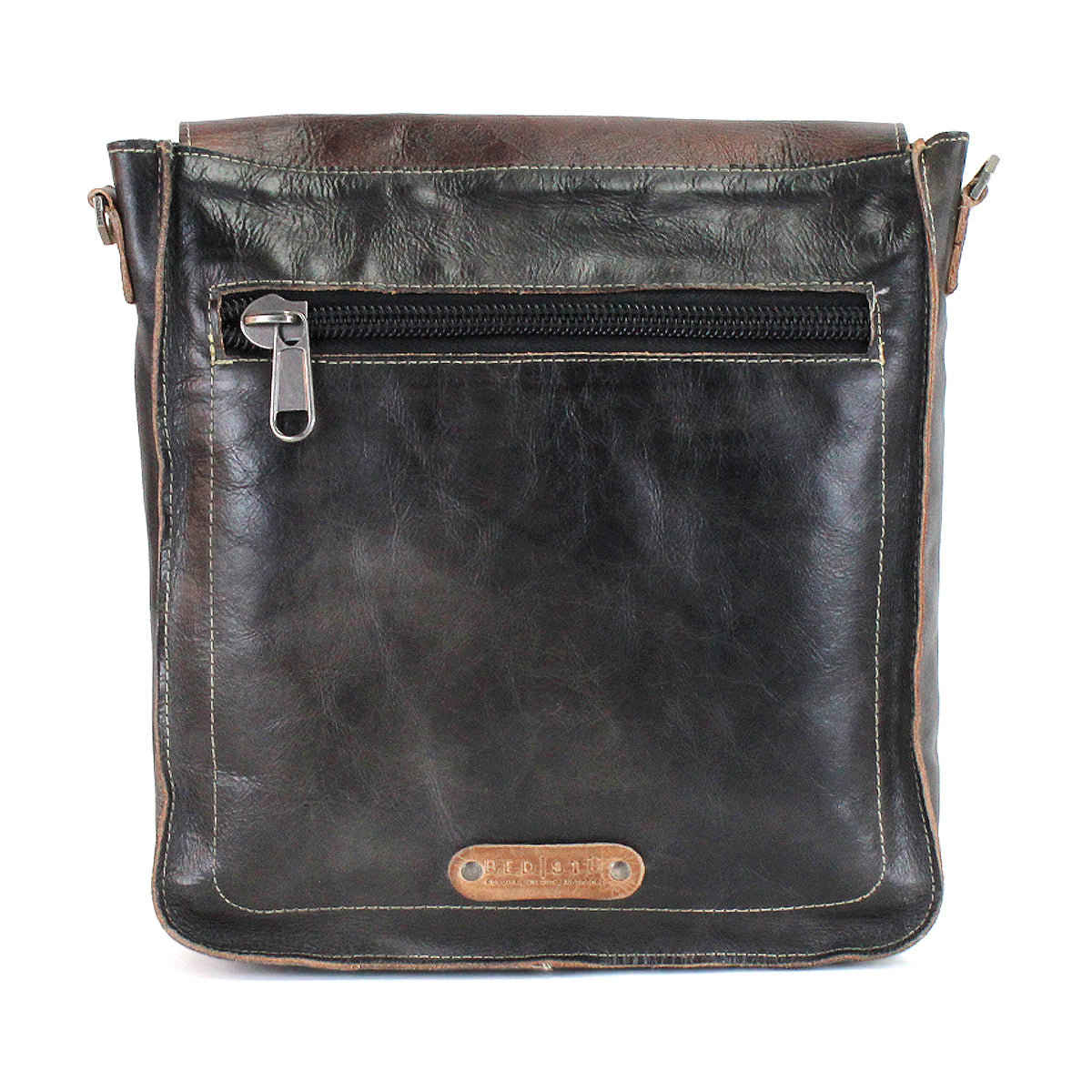 Introducing the Venice Beach by Bed|Stü—a black full-grain leather crossbody bag with brown accents, featuring a front zippered pocket and finished with a small rectangular leather patch stamped with text near the bottom.