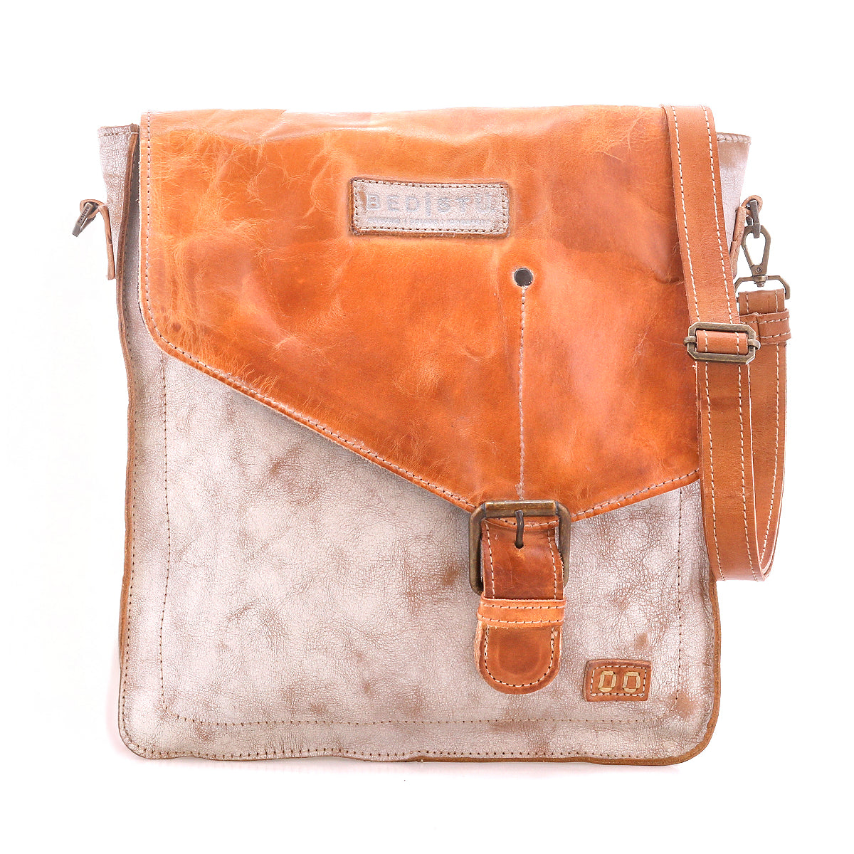 The Venice Beach by Bed Stu is a two-tone crossbody bag made of full-grain leather, featuring a tan flap, buckle closure, and an adjustable shoulder strap.