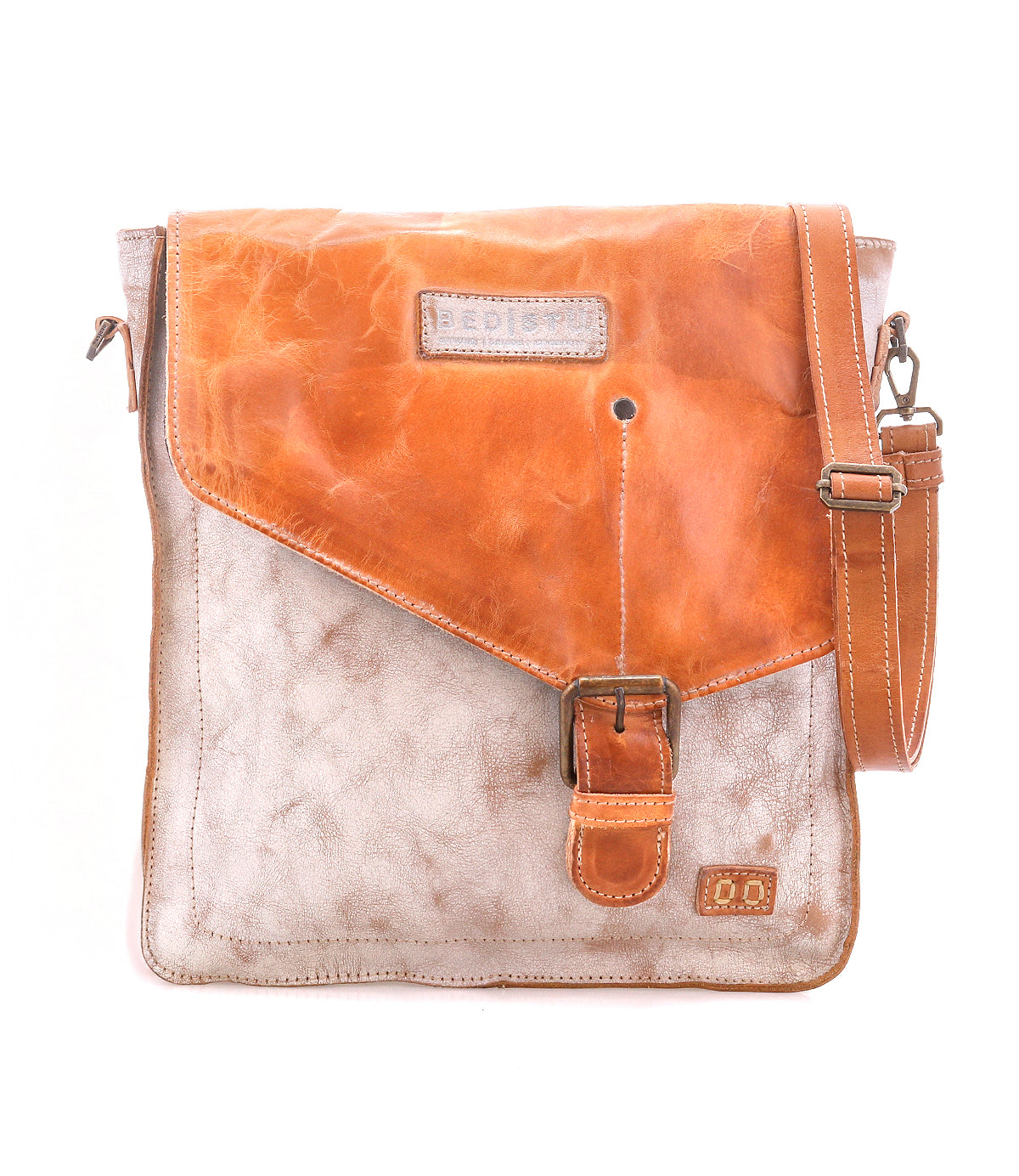 The Venice Beach by Bed Stu is a two-tone crossbody bag made of full-grain leather, featuring a tan flap, buckle closure, and an adjustable shoulder strap.