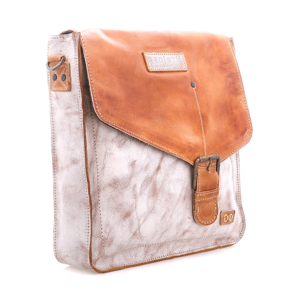 The Bed Stu Venice Beach is a square, light brown full-grain leather messenger bag with a darker tan flap, buckle closure, adjustable strap, and stitched logo patch on the lower right corner, shown against a white background.