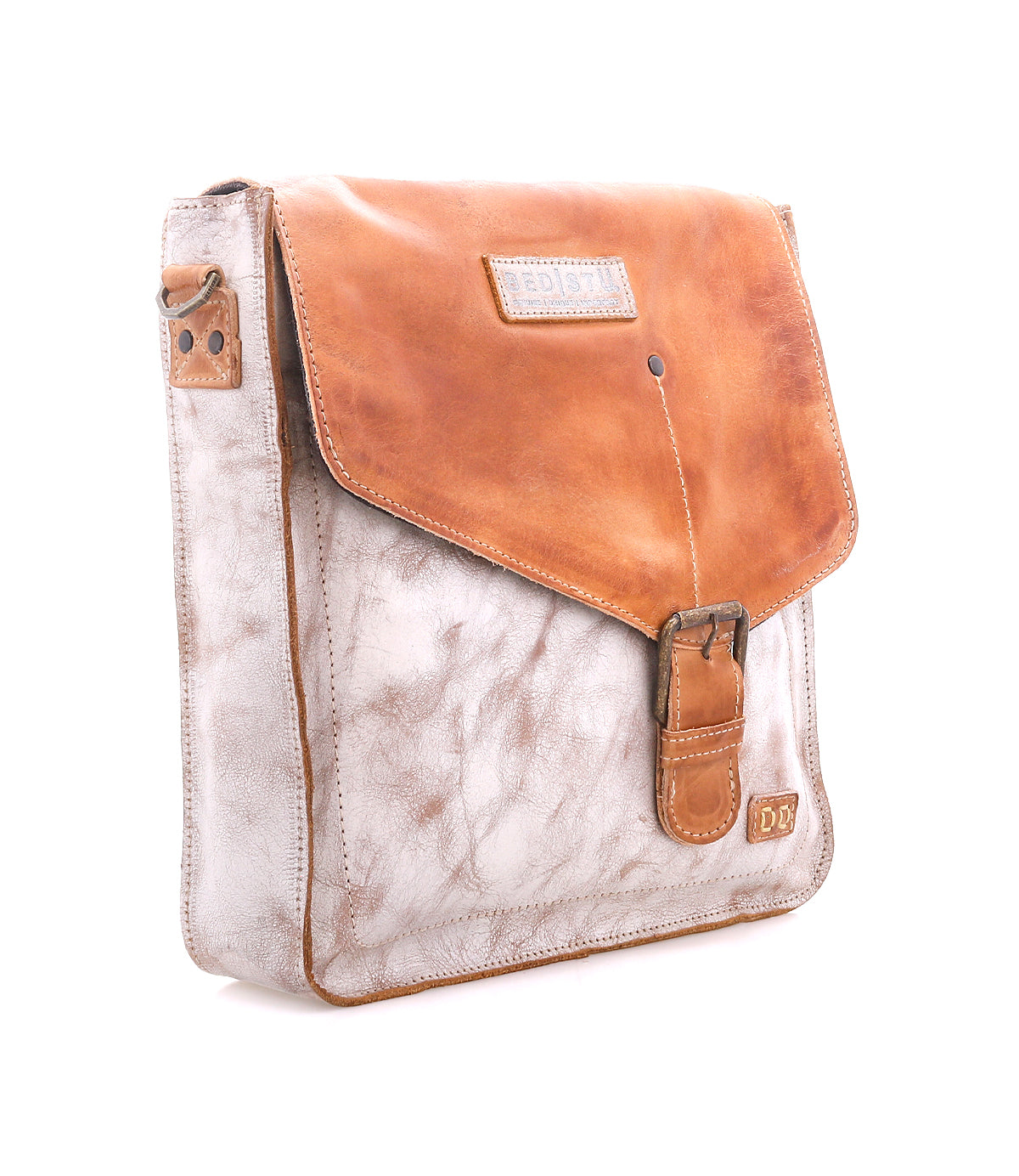 The Bed Stu Venice Beach is a square, light brown full-grain leather messenger bag with a darker tan flap, buckle closure, adjustable strap, and stitched logo patch on the lower right corner, shown against a white background.