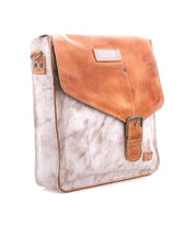 The Bed Stu Venice Beach is a square, light brown full-grain leather messenger bag with a darker tan flap, buckle closure, adjustable strap, and stitched logo patch on the lower right corner, shown against a white background.