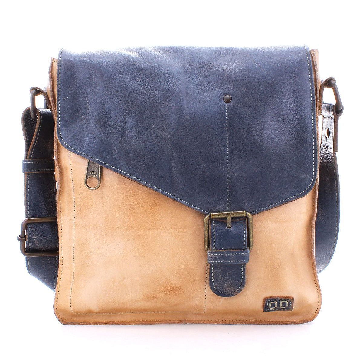 The Venice Beach by Bed Stu is a two-tone, handmade leather crossbody bag, featuring a dark blue flap and beige body. It includes a buckle closure and an adjustable strap. With its bohemian-inspired design, this bag highlights quality craftsmanship, making it both stylish and practical.