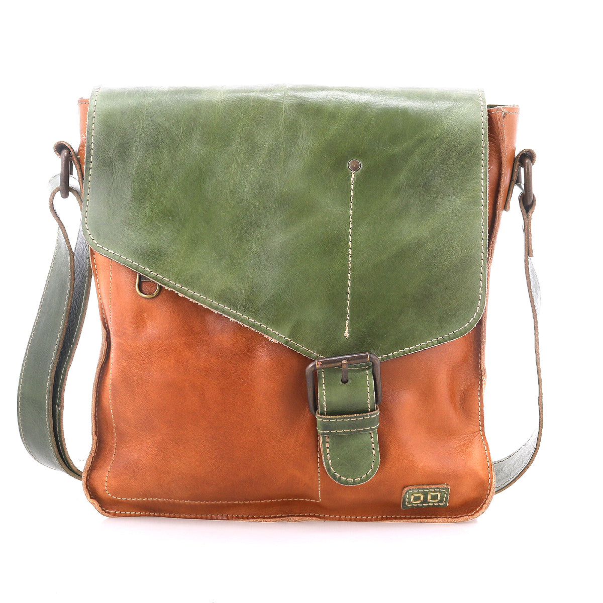 The Bed Stu "Venice Beach" is a brown and green handmade leather crossbody bag with an asymmetrical flap, buckle closure, and adjustable strap, shown against a white background—a bohemian-inspired accessory for unique style.