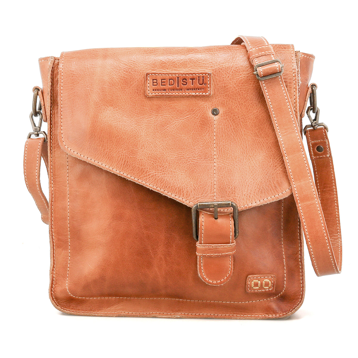The Venice Beach crossbody bag by Bed Stu is handmade from light brown leather, featuring a front flap with buckle closure, adjustable shoulder strap, and the "Bed Stu" logo embossed on the front for a boho-inspired look.