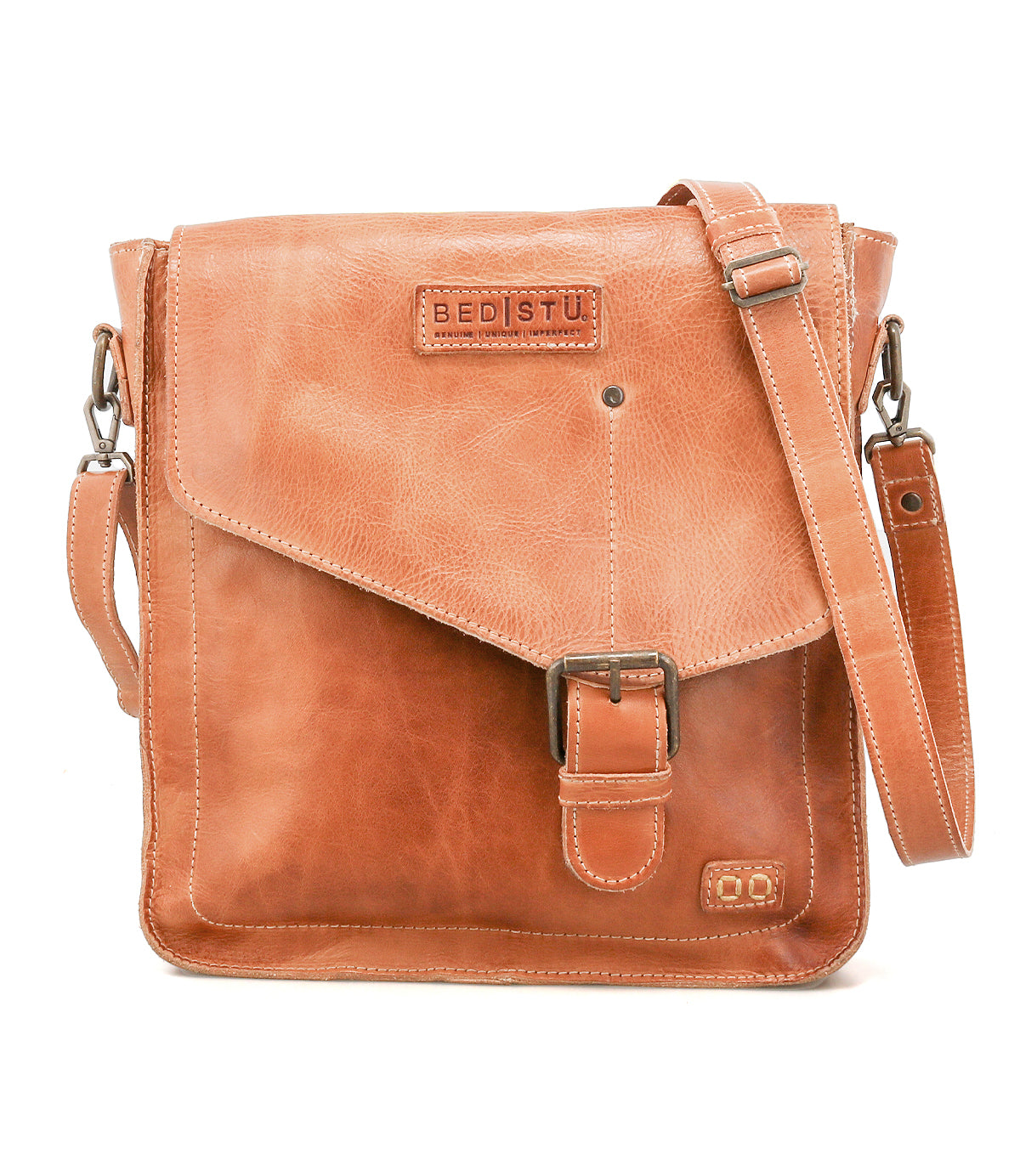 The Venice Beach crossbody bag by Bed Stu is handmade from light brown leather, featuring a front flap with buckle closure, adjustable shoulder strap, and the "Bed Stu" logo embossed on the front for a boho-inspired look.