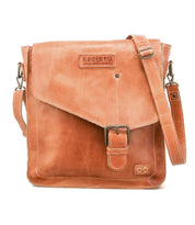 The Venice Beach crossbody bag by Bed Stu is handmade from light brown leather, featuring a front flap with buckle closure, adjustable shoulder strap, and the "Bed Stu" logo embossed on the front for a boho-inspired look.
