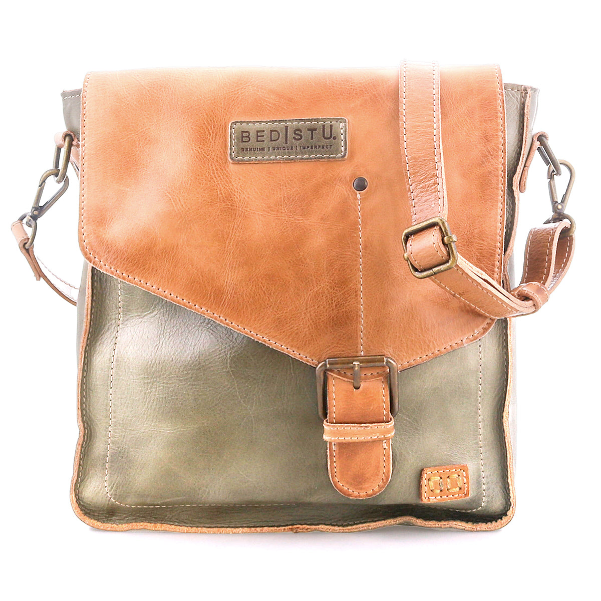 The Bed Stu Venice Beach is a two-tone full-grain leather crossbody bag with a tan flap, buckle closure, adjustable strap, and Bed Stu branding on the front.