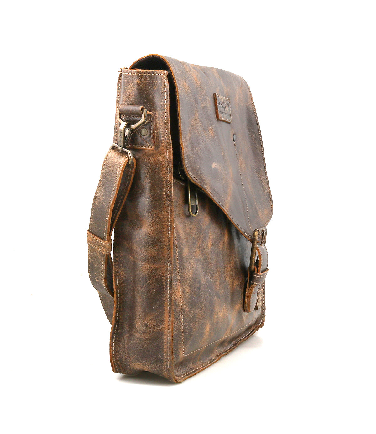 The Bed Stu Venice Beach is a handmade leather crossbody bag with a flap closure, adjustable shoulder strap, and front buckle pocket. This vintage-inspired handbag stands upright on a white background.