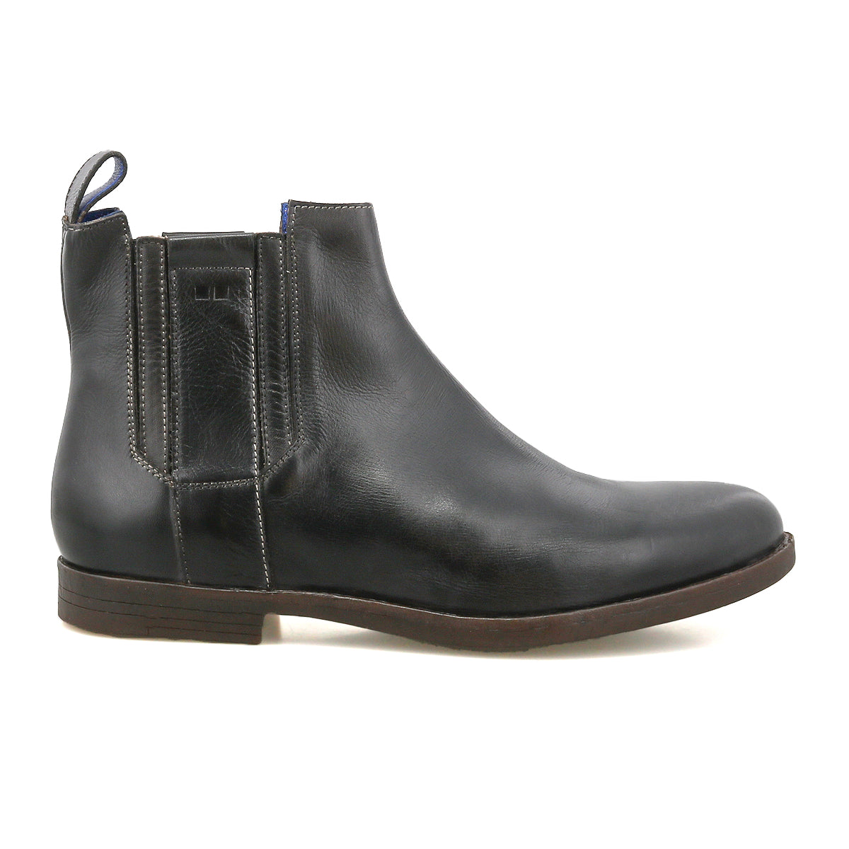 The Bed Stu Verrocchio is a men’s black genuine leather Chelsea boot with elastic side panels, heel pull tab, and a flat brown sole. Features an easy slip-on design, shown from the side.