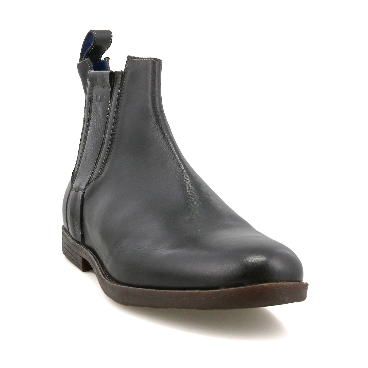 The Bed Stu Verrocchio is a men’s slip-on Chelsea boot crafted in genuine black leather with a brown sole and elastic side panels, displayed from the front on a white background.