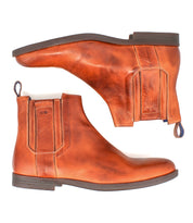 The Bed Stu Verrocchio is a pair of brown genuine leather Chelsea boots with elastic side panels, decorative stitching, pull tabs, and flat dark soles—stylish slip-ons for men shown from the side and bottom.