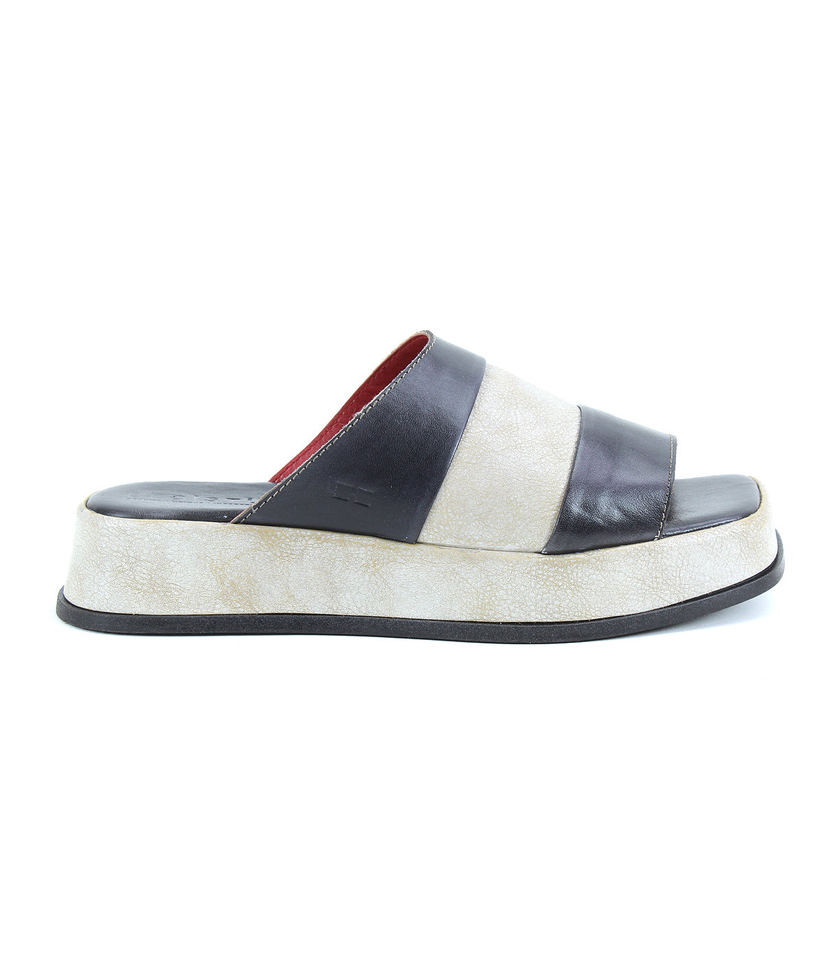 The Bed Stu Vext is a platform slide sandal with a thick, textured off-white sole and two wide dark brown leather straps, offering timeless appeal.