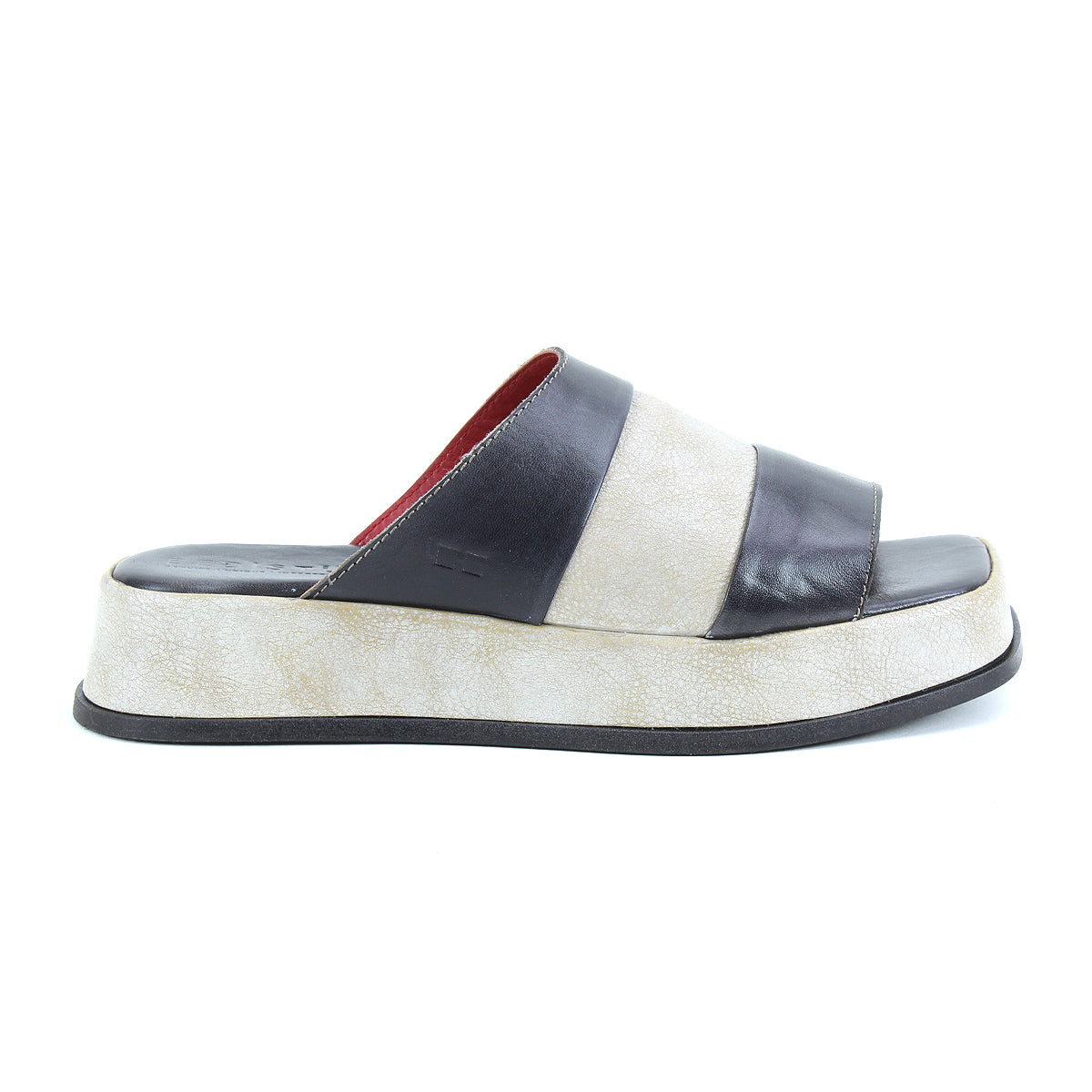 The Bed Stu Vext is a platform slide sandal with a thick, textured off-white sole and two wide dark brown leather straps, offering timeless appeal.