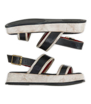 The Bed Stu Vice platform sandals feature black and white hues, adjustable ankle straps, and gold buckles, shown side by side on a white background.