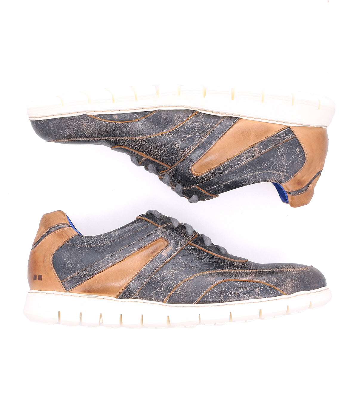 A pair of worn denim Wardell sneakers by Bed Stu with contrast tan leather accents and white soles, displayed against a white background.