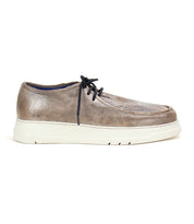 The "Webmaster" sneaker by Bed Stu is designed for casual style and all-day comfort, featuring brown leather, black laces, and a white rubber sole, presented in a side view.