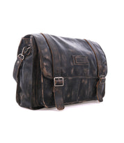 Bed|Stü Wexler spacious dark leather messenger bag with two buckled straps and a flap closure.