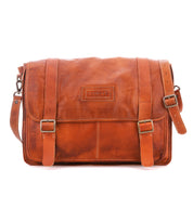 Bed|Stü Wexler spacious tan leather messenger bag with two buckled straps on the front flap and an adjustable shoulder strap.