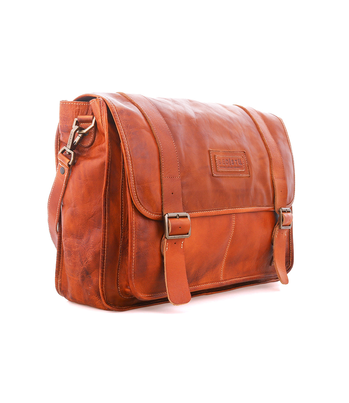 Bed|Stü Wexler spacious tan leather messenger bag with a flap closure, two buckle straps, and a shoulder strap.