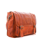 Bed|Stü Wexler spacious tan leather messenger bag with a flap closure, two buckle straps, and a shoulder strap.