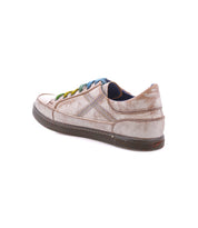 Wizard low-profile leather sneaker by Bed|Stü with a distressed finish, crossover stitching, and multicolored laces.