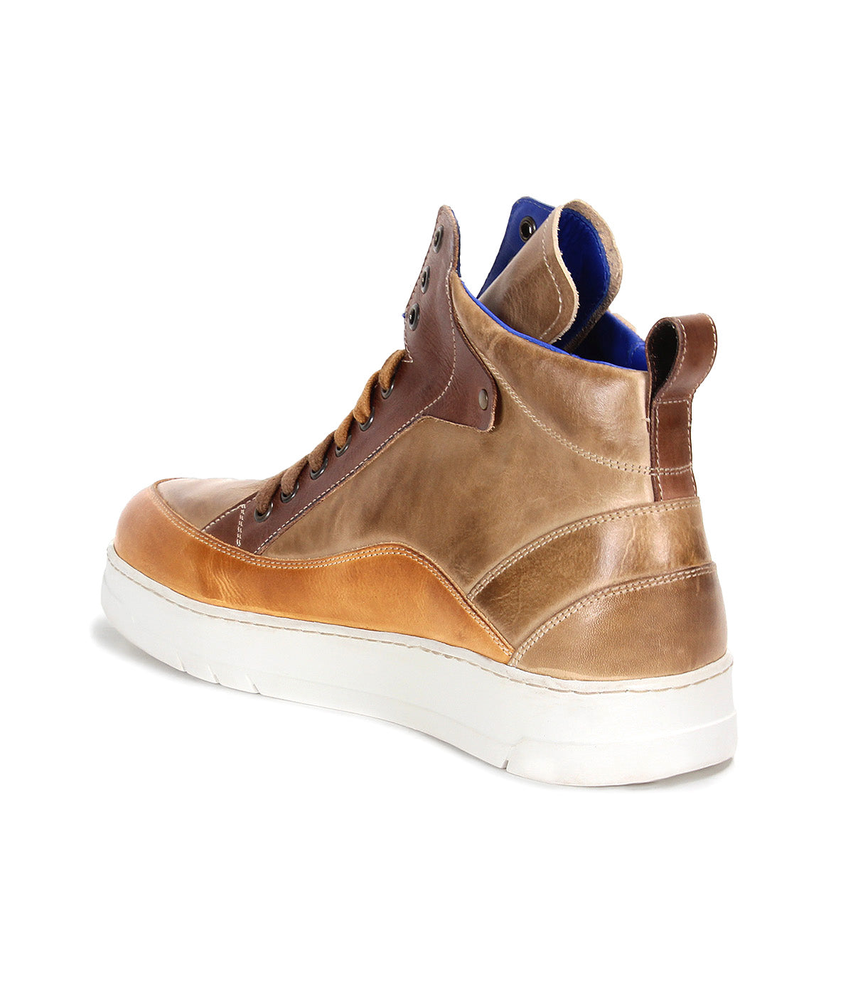 The Bed Stu Workbench is a men’s brown leather sneaker with a white cushioned rubber sole and blue interior lining, featuring a versatile design, shown from the back-left angle.