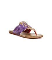 The Yoli by Bed Stu is a brown flat sandal featuring purple woven leather upper straps and an open toe design, shown against a white background.
