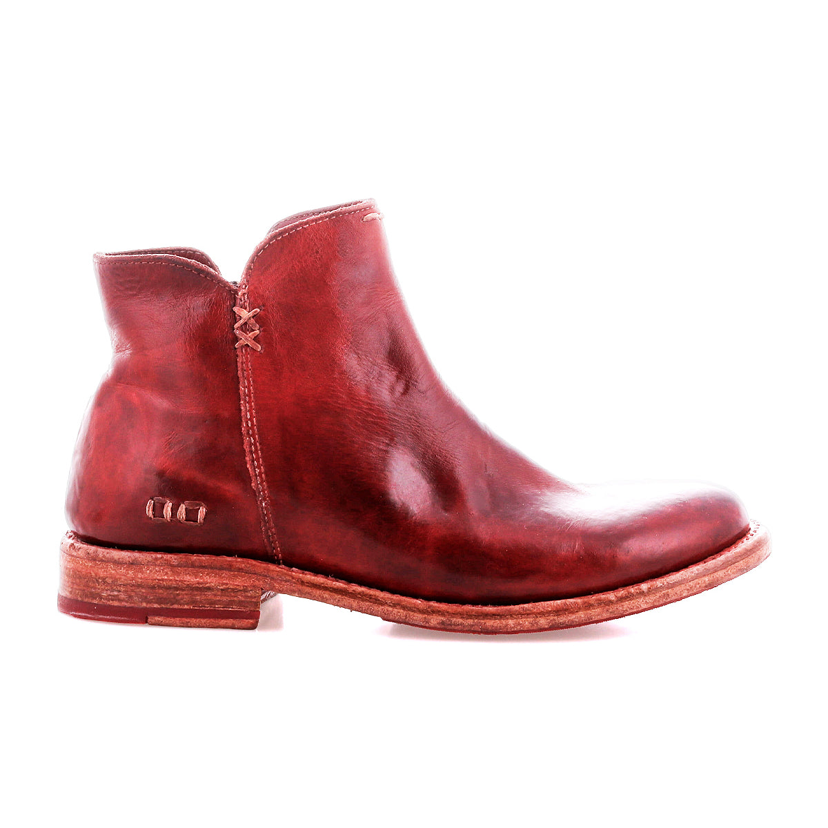 The Bed Stu Yurisa is a red leather ankle boot with a low heel, visible stitching, and a sturdy Vibram outsole—shown in profile on a white background—for the perfect everyday style.