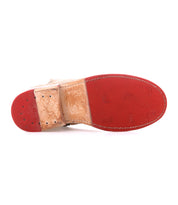 The image displays the underside of the Bed Stu Yurisa dress shoe, featuring a red, partially textured Vibram outsole and visible edge stitching.
