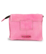 The Ziggy by Bed Stu is a pink leather crossbody bag featuring a front flap closure and a small rectangular patch above its metal-studded logo—perfect for stylish convenience on the go.