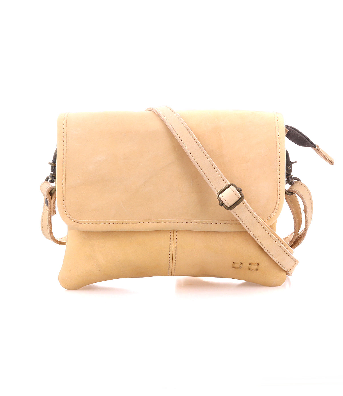 The Bed Stu Ziggy is a tan leather crossbody bag with a front flap, adjustable strap, and minimal stitching for hands-free convenience, shown against a white background.