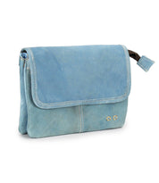 The Bed Stu Ziggy is a light blue leather crossbody bag featuring a flap closure, white stitching, and two small square metal accents on the bottom right corner.