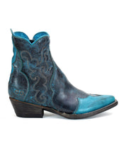 The Ace by Bed Stu is a blue and black leather ankle cowgirl boot featuring decorative stitching, a low heel, and a durable stacked leather sole, exemplifying modern western style.