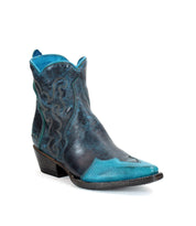The Bed Stu "Ace" cowboy boot in black and blue features intricate patterns, a pointed toe, and a short heel made from durable stacked leather, isolated on a white background.