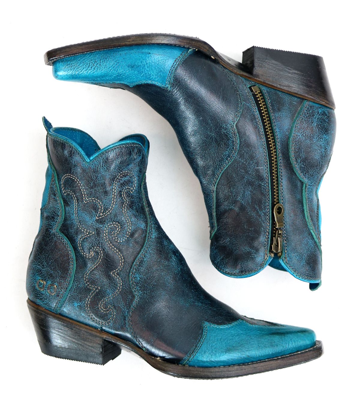The Ace boots by Bed Stu are a pair of blue and black leather cowboy boots featuring intricate stitching, a side zipper, and durable stacked leather, embodying a modern western style.