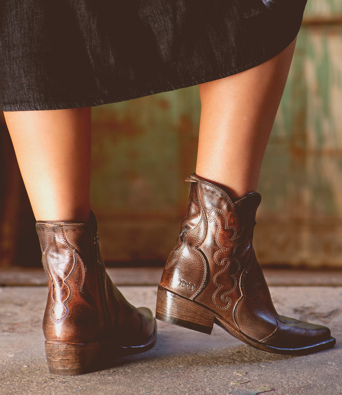 A woman sporting comfortable Ace leather cowboy boots with western style flair. (Brand Name: Bed Stu)